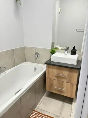 a bathroom with a white tub and a sink at The four ones in Nelspruit