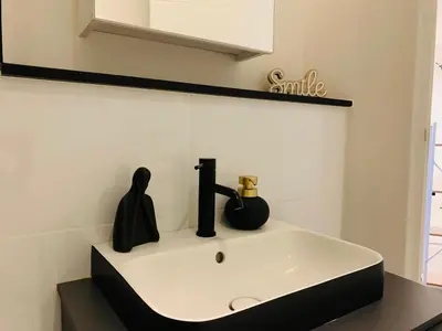 a bathroom sink with a black and white at Luxury Studio Apartment in Northdene