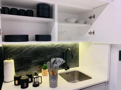 a kitchen with a sink and a counter with dishes at Luxury Studio Apartment in Northdene
