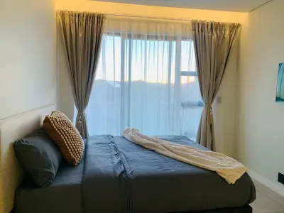 a bedroom with a bed with a large window at Luxury Studio Apartment in Northdene