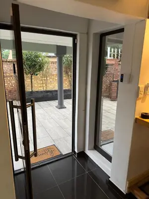 an open door with a view of a courtyard at Pillowtalk guest house your home away from home in Middelburg