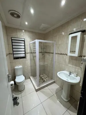 a bathroom with a shower and a toilet and a sink at Pillowtalk guest house your home away from home in Middelburg
