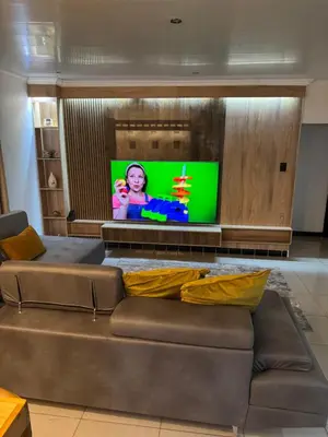 a living room with a couch and a flat screen tv at Pillowtalk guest house your home away from home in Middelburg