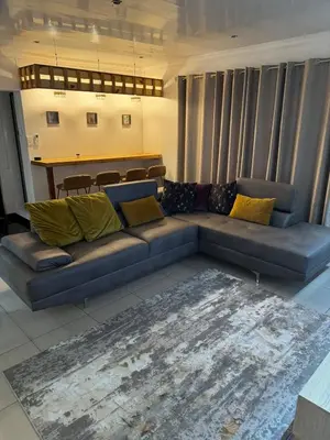 a living room with a couch and a table at Pillowtalk guest house your home away from home in Middelburg