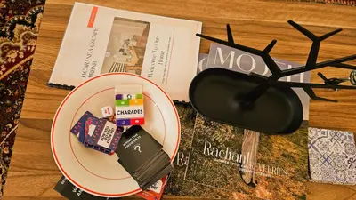 a table with a plate with a pair of glasses and a book at Jacaranda Escape in Pretoria