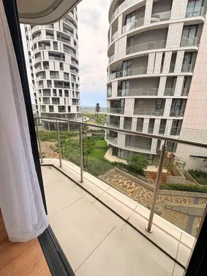 a balcony with a view of a large building at Elite Skyline Suite, Ellipse, Waterfall City in Midrand
