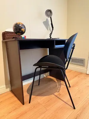 a black desk with a chair and a lamp at Elite Skyline Suite, Ellipse, Waterfall City in Midrand
