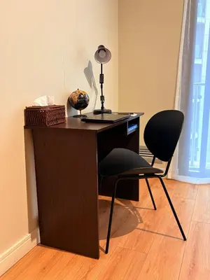 a desk with two chairs and a lamp on it at Elite Skyline Suite, Ellipse, Waterfall City in Midrand