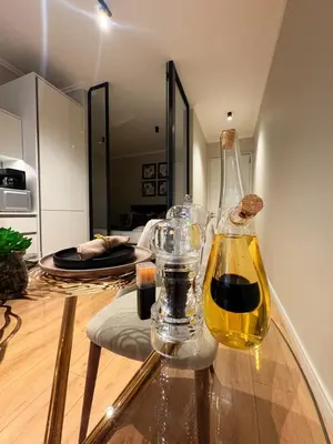 a bottle of wine sitting on top of a glass table at Elite Skyline Suite, Ellipse, Waterfall City in Midrand