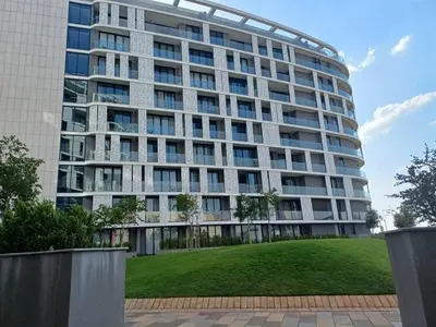 a large building with a green lawn in front of it at Elite Skyline Suite, Ellipse, Waterfall City in Midrand