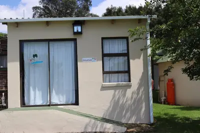 a house with a large door and two windows at Jonatan at Genesaret in Lake Chrissie