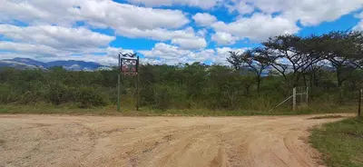 a dirt road with a sign on the side of it at Daisy Lodge in Barberton