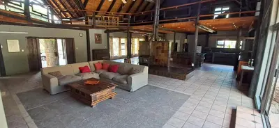 a living room with a couch and a coffee table at Daisy Lodge in Barberton