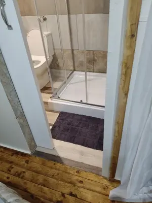 a bathroom with a shower with a tub at The Man Cave Extension in Sabie
