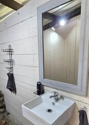 a bathroom with a sink and a mirror at Glamping tent in Nelspruit