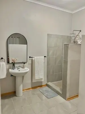 a bathroom with a sink and a shower at Lily Palms Rest in Tzaneen