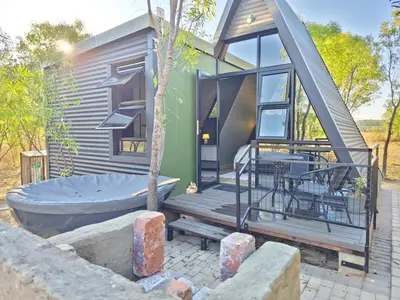 a tiny house with a tub in the yard at The Triangle Retreat - Modimolle in Modimolle