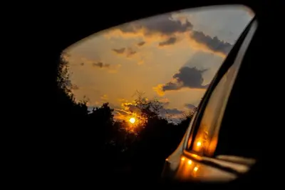 a reflection of a sunset in the rear view mirror of a car at Trinity Pod - Modimolle in Modimolle