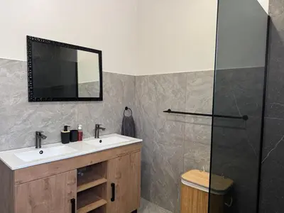 a bathroom with a sink and a shower at Accommodation in Lynwood Pretoria East for larger groups and Families in Pretoria