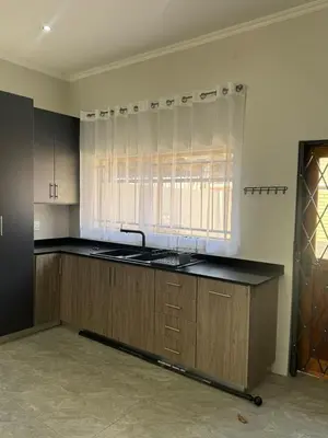 an empty kitchen with a sink and a window at Accommodation in Lynwood Pretoria East for larger groups and Families in Pretoria