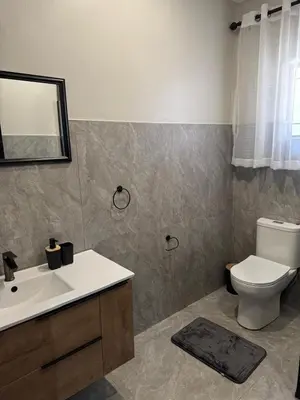 a bathroom with a toilet and a sink and a mirror at Accommodation in Lynwood Pretoria East for larger groups and Families in Pretoria
