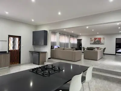 a large living room with a table and chairs at Accommodation in Lynwood Pretoria East for larger groups and Families in Pretoria