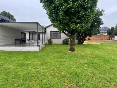 a tree in a yard next to a house at Accommodation in Lynwood Pretoria East for larger groups and Families in Pretoria