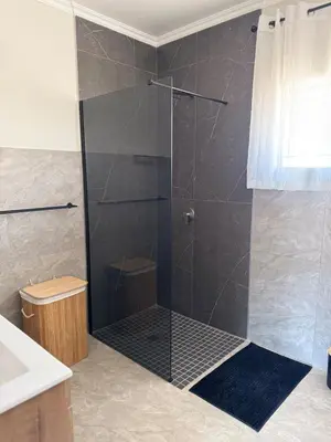 a shower with a glass door in a bathroom at Accommodation in Lynwood Pretoria East for larger groups and Families in Pretoria