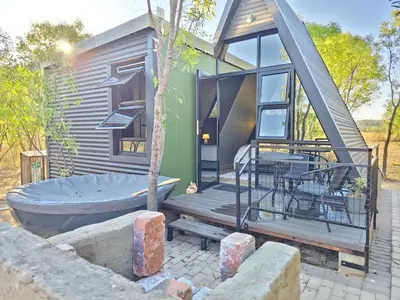a tiny house with a tub on a patio at Braai & Bubbles - Modimolle in Modimolle