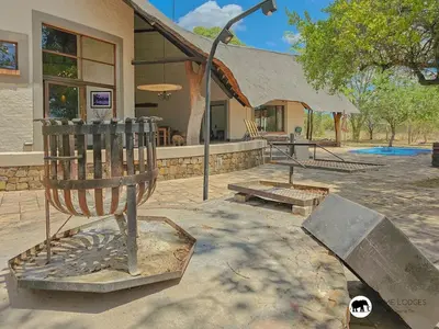 a park with a playground in front of a building at Sarabi Lodge - Zebula in Warmbaths
