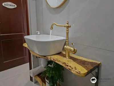 a white sink on a wooden table in a bathroom at Sarabi Lodge - Zebula in Warmbaths
