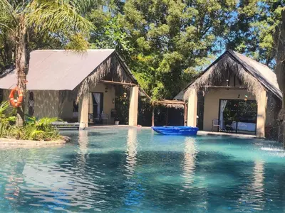 a swimming pool in front of a house at Waterfall Cabana 3 - Beach Island in Graskop
