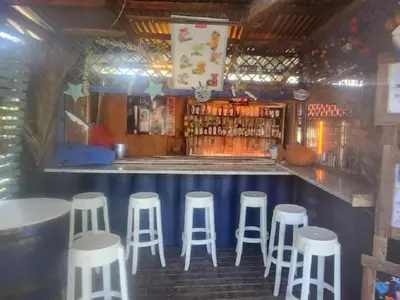 a bar with five white stools in a room at Waterfall Cabana 3 - Beach Island in Graskop