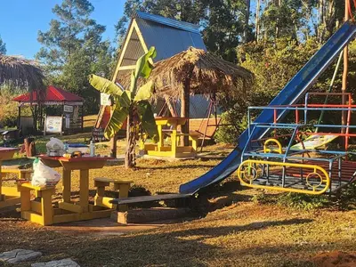 a playground with a slide in front of a house at Waterfall Cabana 3 - Beach Island in Graskop