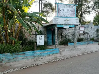 a building with a sign on the side of a street at Waterfall Cabana 3 - Beach Island in Graskop