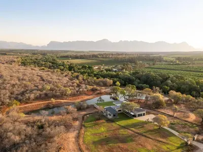an aerial view of a home with a river and trees at Niemandsland in Hoedspruit