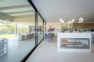 a living room with a fireplace in a house at Niemandsland in Hoedspruit