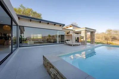a swimming pool in the backyard of a house at Niemandsland in Hoedspruit