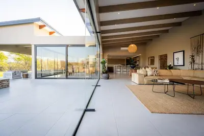 a living room with a couch and a table at Niemandsland in Hoedspruit