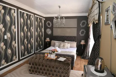 a living room with a bed and a couch at Jinaguesthouse and design in Polokwane
