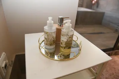 a gold tray with two bottles on a table at Jinaguesthouse and design in Polokwane