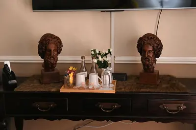 a table with two head busts on top of it at Jinaguesthouse and design in Polokwane