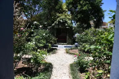 a garden with a pathway with flowers and plants at Jinaguesthouse and design in Polokwane