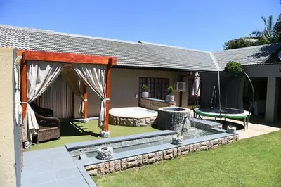 a backyard with a pool and a table and a tent at Jinaguesthouse and design in Polokwane