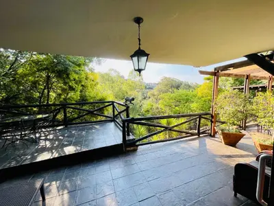 a balcony of a house with a view of trees at Waterkloof Heights Guest House in Pretoria