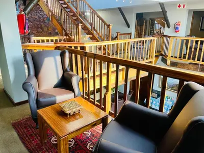 a living room with two chairs and a table at Waterkloof Heights Guest House in Pretoria