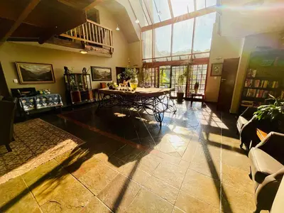 a large living room with a table and chairs at Waterkloof Heights Guest House in Pretoria