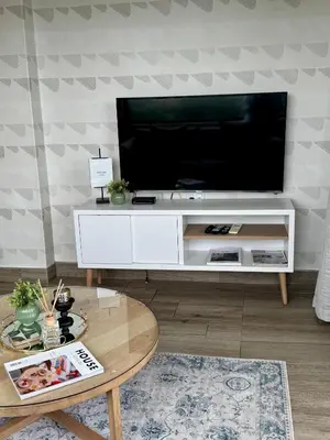 a living room with a television on a white entertainment center at 214 Executive Suite, in Pretoria