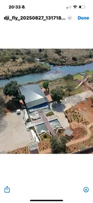 a screenshot of a webpage of a river and buildings at Makonde river lodge in Makonde