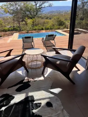 a patio with a table and chairs and a pool at Makonde river lodge in Makonde